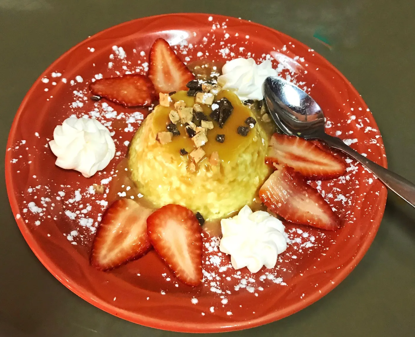 A dessert plated with strawberries and whipped cream
